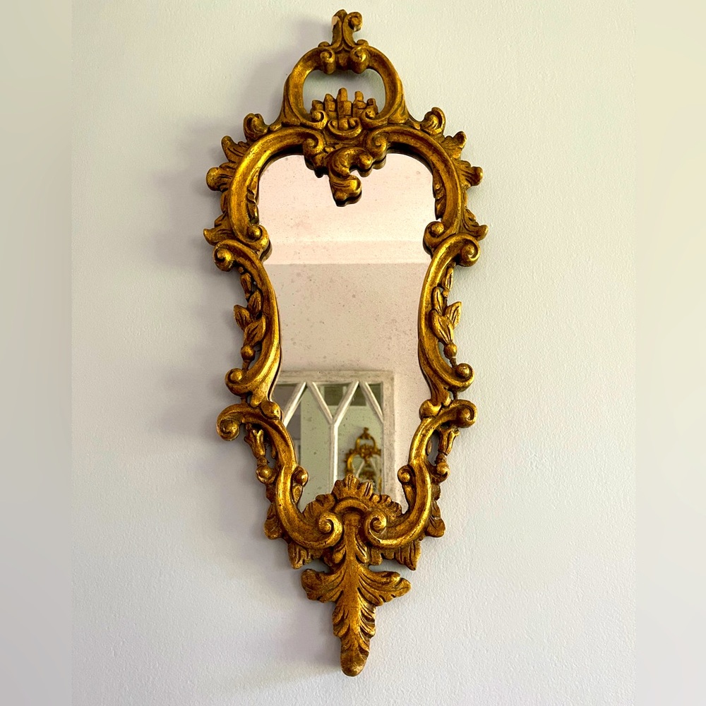Baroque style vintage gilded mirror. Missing a small piece of wood, pictured.